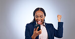 Business woman, winning and phone in studio for success, celebrate profit and bonus promotion on grey background. Excited african worker, achievement and fist for mobile deal, news of reward or prize