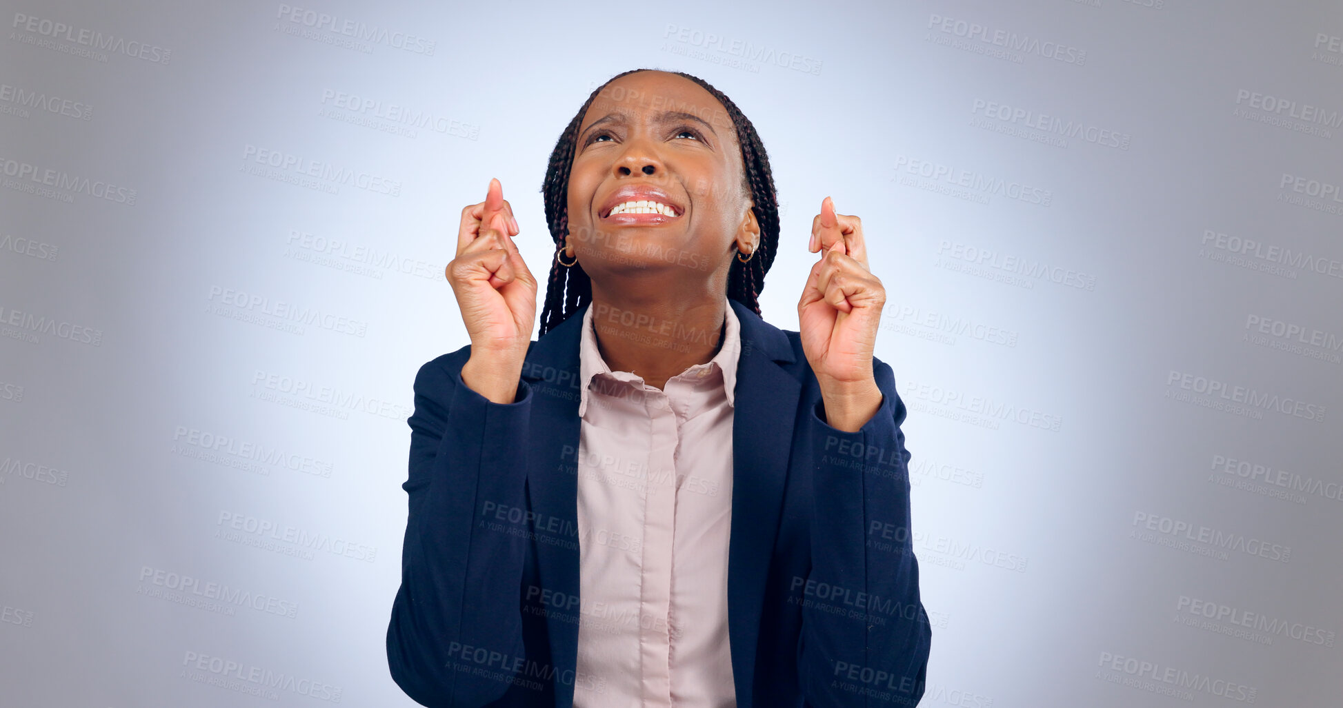 Buy stock photo Business woman, fingers crossed and hope in studio for luck, thinking of wish or waiting for announcement on grey background. Nervous african worker, hand emoji or anxiety while praying for good news