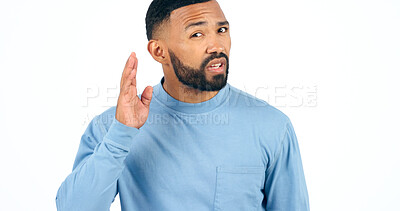 Buy stock photo Portrait, secret or gossip with a man listening in studio isolated on a white background for communication. Face, hand and hearing with a young person looking confused about news, audio or sound
