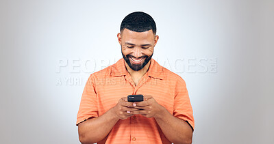 Buy stock photo Man, smartphone and chat online with social media and communication in studio on white background. Smile at text, email notification and scroll internet with typing, mockup space and using phone