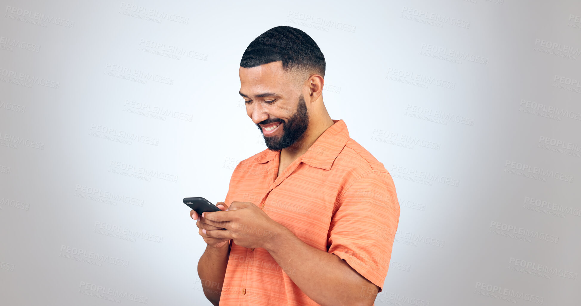 Buy stock photo Phone, chat and happy man laugh in studio with online comic, meme or funny text on grey background. Smartphone, smile or male model with app joke, humor and contact or web, network or communication