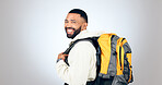 Man, happy portrait and hiking in studio with backpack and smile from travel and freedom with adventure. Camping, fitness and grey background and walking with camper gear for vacation and holiday