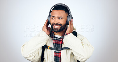 Buy stock photo Man, travel and listening with headphones for music in studio, background or streaming audio. Radio, podcast and person hiking and relax with hip hop or download sound online to hear with technology 