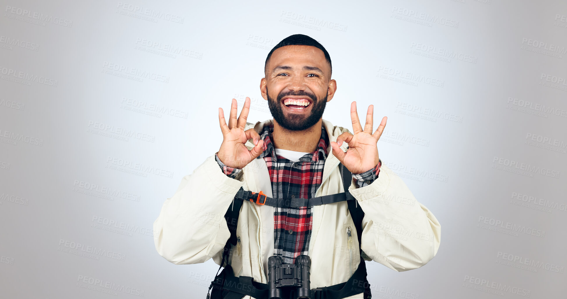 Buy stock photo Perfect sign, hiker and portrait of man in a studio with a backpack for hiking adventure. Happy, smile and young male person from Mexico with ok hand gesture for camping isolated by gray background.