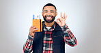 Ok sign, portrait and man with a passport, smile and vacation on white studio background. Face, model and tourist with tickets, perfect symbol and travelling with mockup space, agreement and holiday