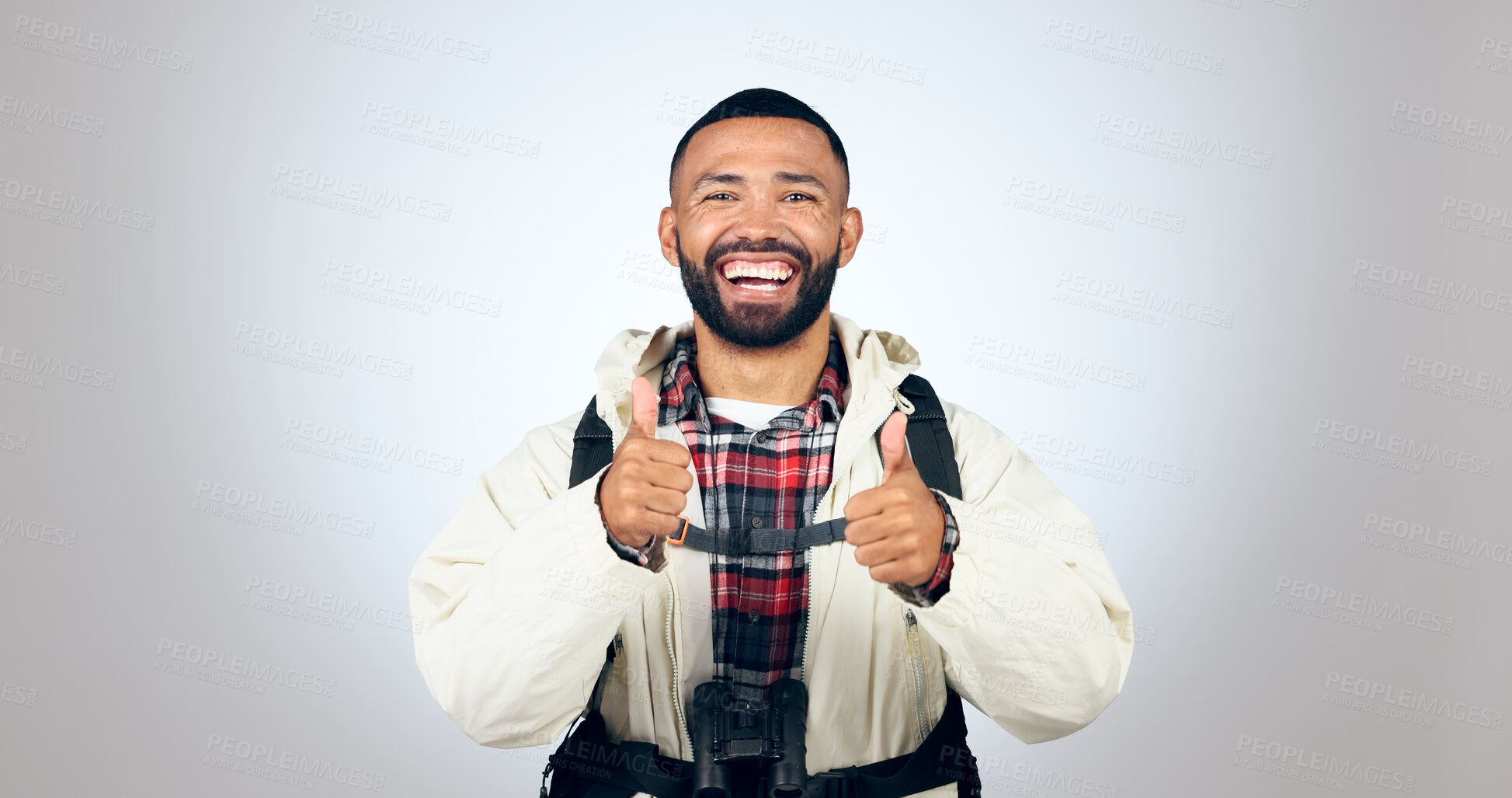 Buy stock photo Man, portrait and thumbs up in studio with backpack and smile from travel freedom with adventure. Camping, fitness and grey background and yes with trekking gear for vacation with hiking motivation