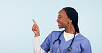 Smile, information and a nurse black woman pointing to space in studio on a blue background for healthcare. Medical, presentation and checklist with a happy young medicine professional showing mockup