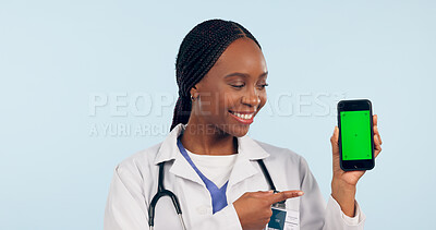 Buy stock photo Green screen, doctor pointing and black woman with phone for telehealth, wellness app and medical news. Healthcare, mockup and person on smartphone for clinic website, promotion and contact in studio