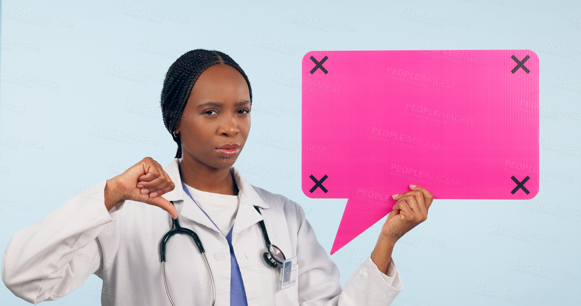 Buy stock photo Black woman, doctor and thumbs down with speech bubble for social media or bad review against a studio background. Portrait of African female person, surgeon or nurse showing icon, no sign or mockup