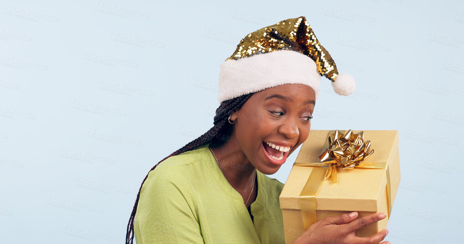 Buy stock photo Excited black woman, box and Christmas surprise for gift, present or prize against a studio background. Face of happy and surprised African female person holding ribbon package, parcel or gifts