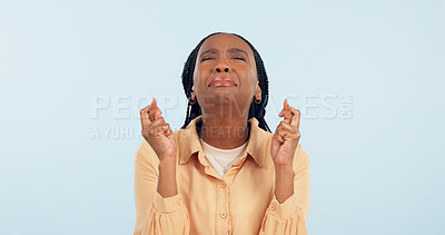 Buy stock photo Nervous, woman and hope with fingers crossed in studio for lucky news, feedback and waiting with anxiety on blue background. African model, worry and stress with hand sign for wish, praying and emoji