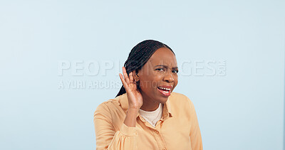 Buy stock photo Woman, hand and ear in studio for gossip, story and frustrated face in portrait by blue background. African girl, hearing and confused for secret information, news and communication with questions