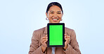 Portrait, tablet and green screen space with an asian woman in studio on a blue background for website promotion. Tech, mockup or chromakey and a person holding a display with tracking markers