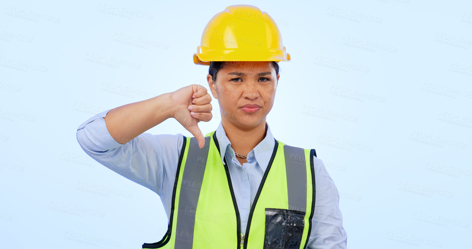 Buy stock photo Woman, thumbs down and engineer for construction by architect in studio by blue background. Asian female, development and negative review for real estate fail, inspection and dislike in mockup