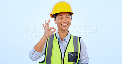 Buy stock photo Woman, okay and hands in smile by engineer for construction by architect in studio by blue background. Asian female, development or success for real estate, inspection and yes sign or emoji in mockup