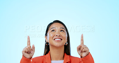 Buy stock photo Business woman, face and pointing up in studio for advertising choice, decision and information about us on blue background. Happy asian worker, thinking and presentation of mockup ads, ideas or deal