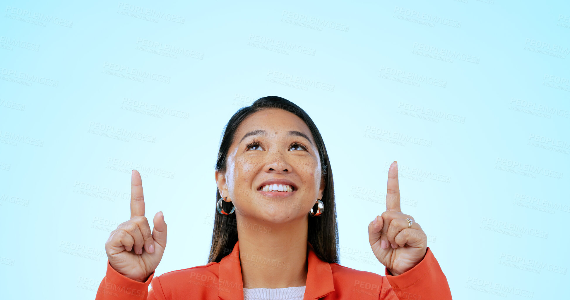 Buy stock photo Business woman, face and pointing up in studio for advertising choice, decision and information about us on blue background. Happy asian worker, thinking and presentation of mockup ads, ideas or deal