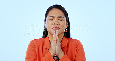 Buy stock photo Hope, religion and woman with faith, praying and gratitude on a blue studio background. Person, girl and model with gesture, prayer and spirit with guidance, Christian and emoji with stress and peace