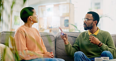 Buy stock photo Fight, couple and home with marriage stress, frustrated and angry man on a living room sofa. Mistake, yelling and conversation of people with argument, fail and conflict with divorce discussion