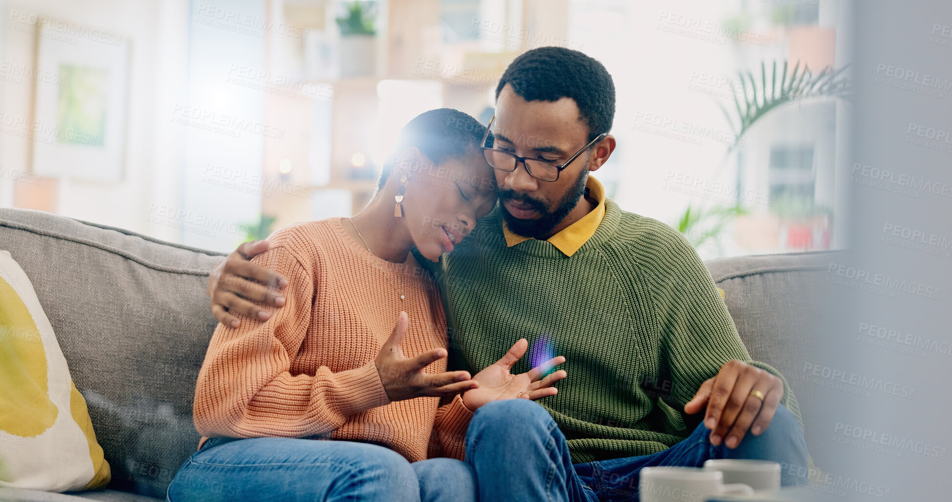 Buy stock photo Sad, home and black couple with hug, conversation and emotions with discussion, grief and loss. People, apartment and man with woman, embrace or talking with reaction, crying and support with anxiety