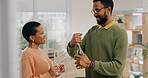 African couple, glasses and champagne in home with smile, celebration and party for success in living room. Black woman, man and bottle of sparkling wine for achievement, goals and drink in house