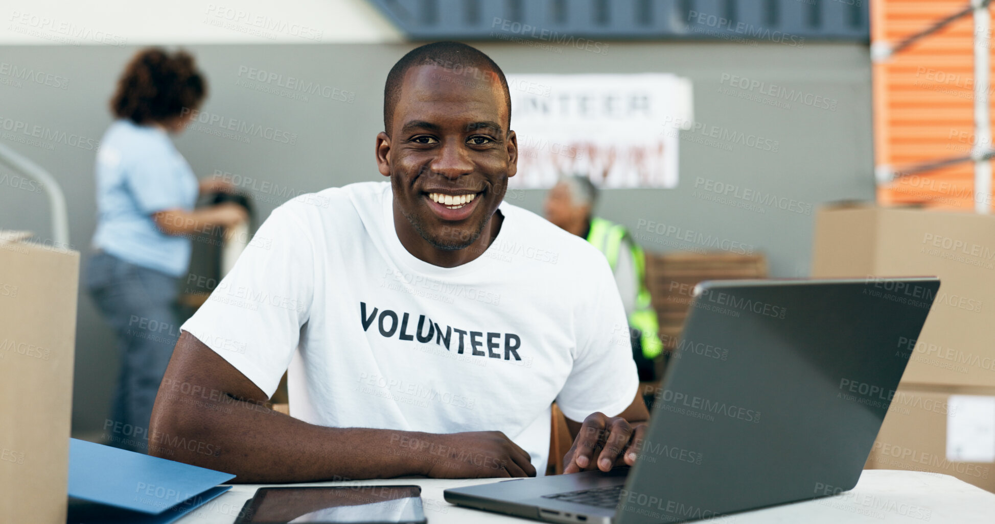 Buy stock photo Volunteer man, laptop and portrait for donation, clothes drive and smile for community service, scroll and web. African person, pc and social responsibility with boxes, charity and ideas for helping