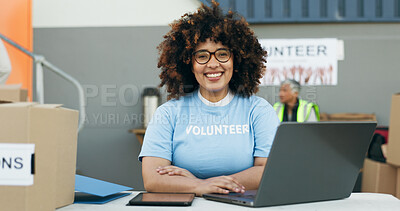 Buy stock photo Volunteer woman, laptop and portrait at clothes drive with smile, community service and kindness at desk. Girl, computer and social responsibility with donation boxes, charity and happy for helping