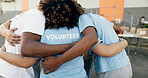 Community, charity and a volunteer group in a huddle together for teamwork, unity or solidarity. Recycle, team building and sustainability with ngo people hugging in support of an earth day project