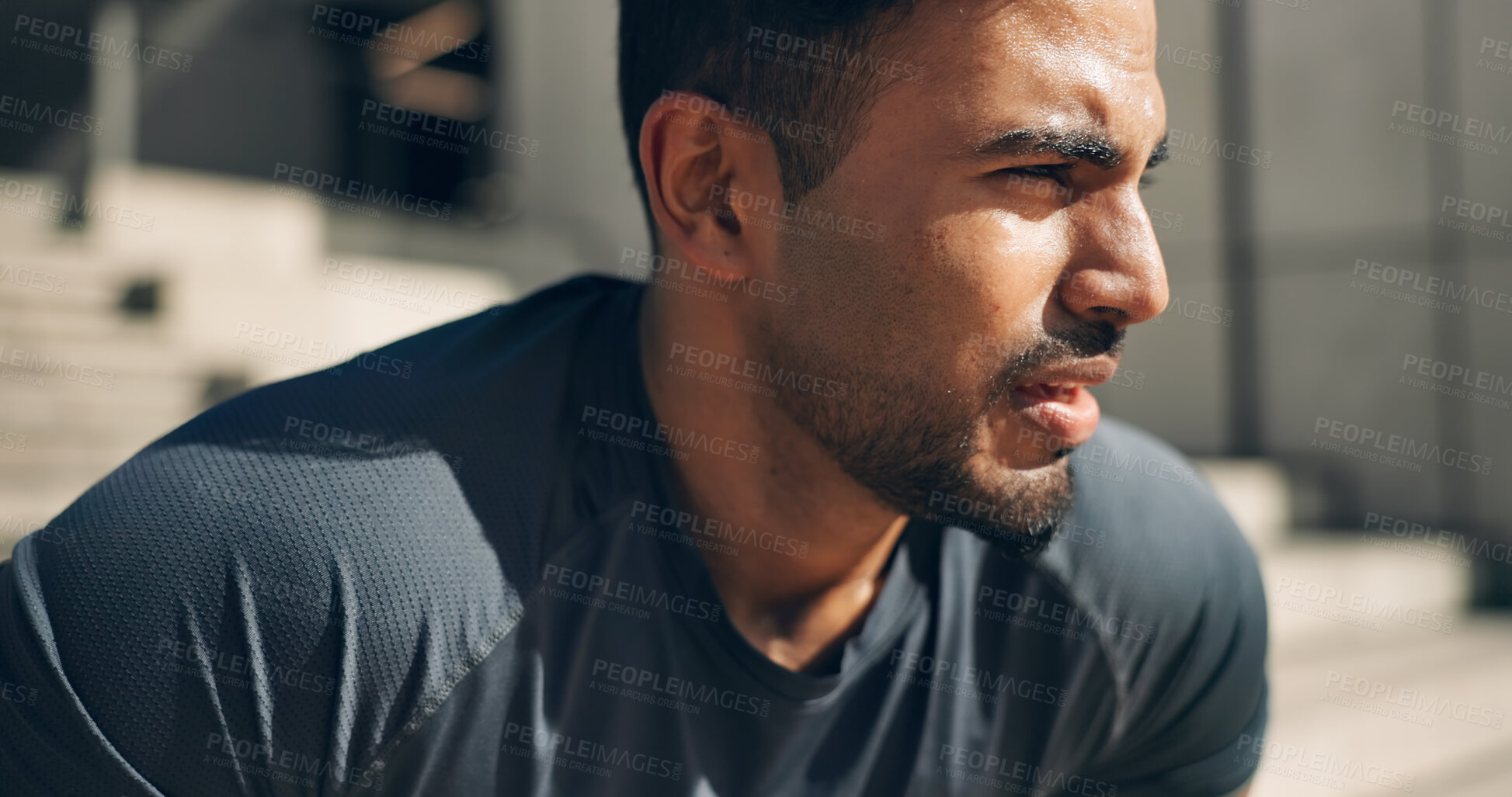 Buy stock photo Face, fitness and a tired sports man outdoor in the city for commitment to health or wellness. Fatigue, breathing and sweating with an exhausted young athlete in an urban town for exercise training