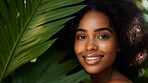 Happy woman with radiant health skin. Portrait of young female surrounded by plants