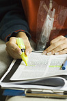 Hand, study highlight and student with a textbook closeup in a home for education, learning or growth. Paper, writing and school with a person reading information at a desk for university scholarship