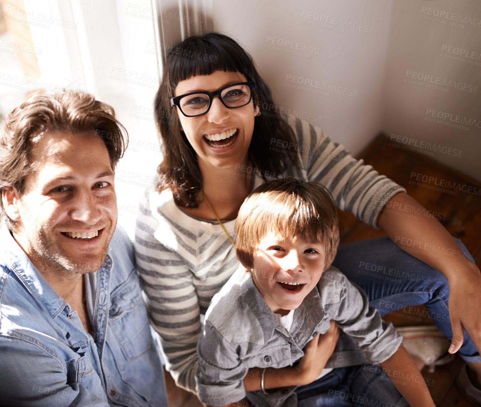 Buy stock photo A mother and father sitting with their son