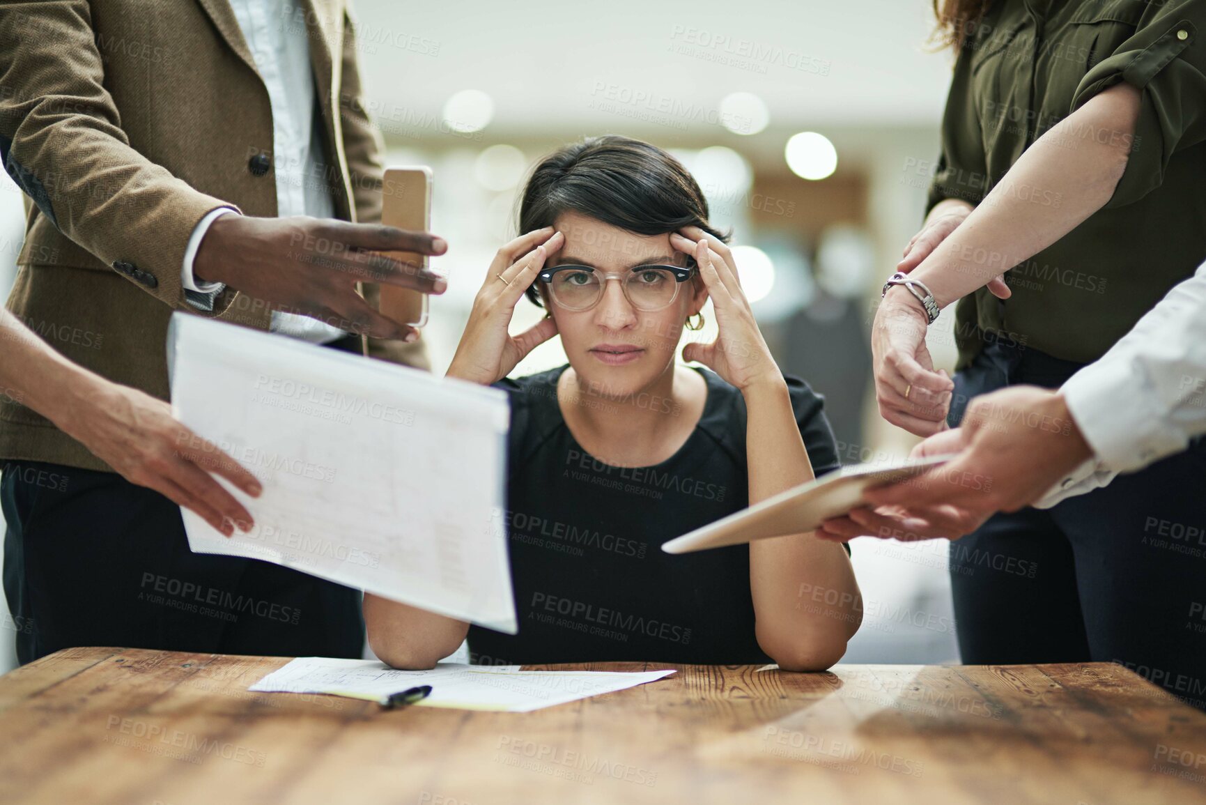 Buy stock photo Cropped portrait of a young businesswoman feeling overwhelmed by her colleagues in the office