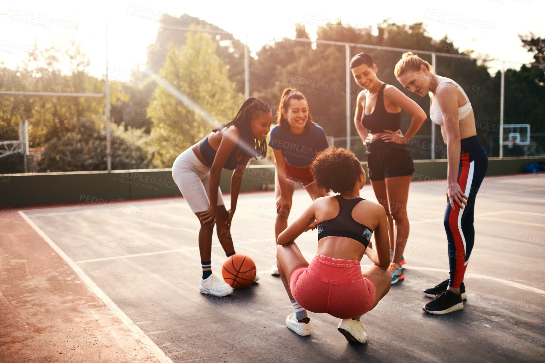 Buy stock photo Cropped shot of a diverse group of friends getting ready to play a game of basketball together during the day