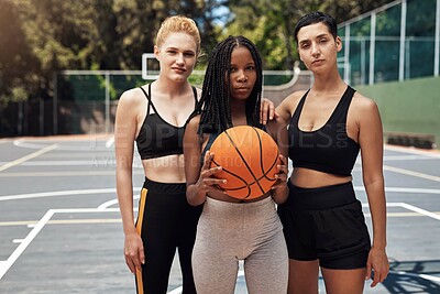 Buy stock photo Portrait of a group of sporty young women standing together on a sports court