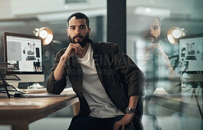 Buy stock photo Portrait of a confident young businessman working late at night in a modern office