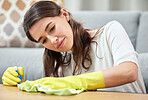 Woman, cloth and gloves with spray for table, chemical or cleaning for hygiene in home living room. Girl, cleaner and services in ppe, fabric or product for dust, shine or stop bacteria on furniture