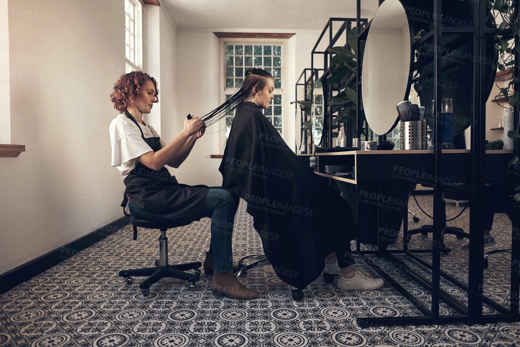 Buy stock photo Shot of a little girl getting her hair done at the salon