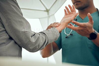 Buy stock photo Cropped shot of an unrecognizable male physiotherapist working on a female patient outside