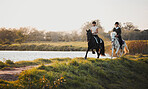 Horse riding, freedom and equestrian with friends in nature on horseback by the lake during a summer morning. Countryside, hobby and female riders outdoor together for travel, fun or adventure