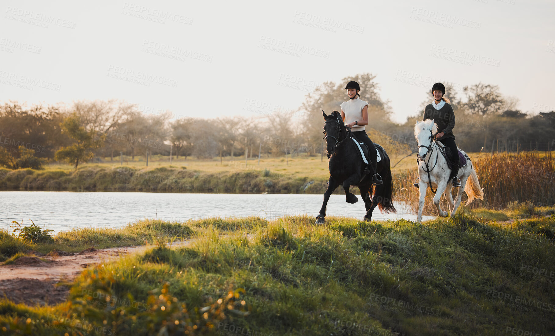 Buy stock photo Horse riding, freedom and equestrian with friends in nature on horseback by the lake during a summer morning. Countryside, hobby and female riders outdoor together for travel, fun or adventure