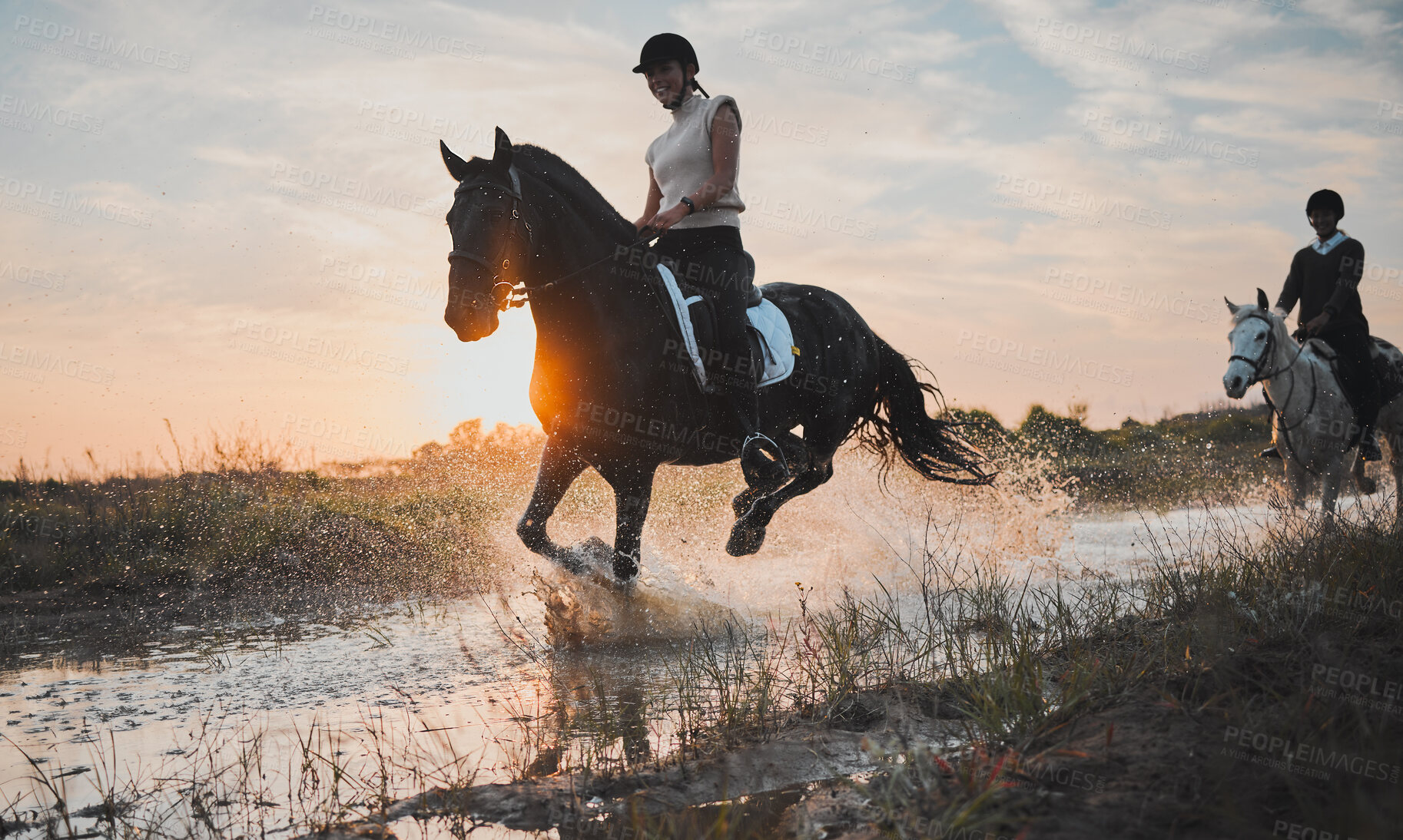 Buy stock photo Adventure, horse riding and sunset with water or girl for travel in summer or weekend in field. Female rider, vacation and animal in river is happy with equestrian or stallion with sunshine, nature.