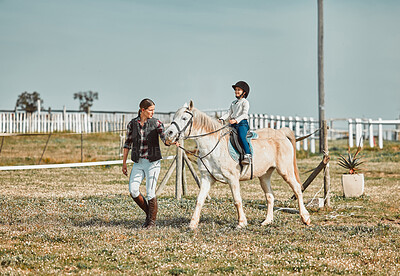 Buy stock photo Lesson, help and woman with a child on a horse for learning, sports and hobby on a farm in Italy. Helping, support and coach teaching a girl horseback riding for a physical activity in countryside