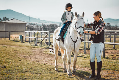 Woman leading girl on horse, ranch and equestrian sports, lady, child and animal walking on field. Countryside lifestyle, rural nature and farm animals, mother teaching happy kid to ride pony in USA.