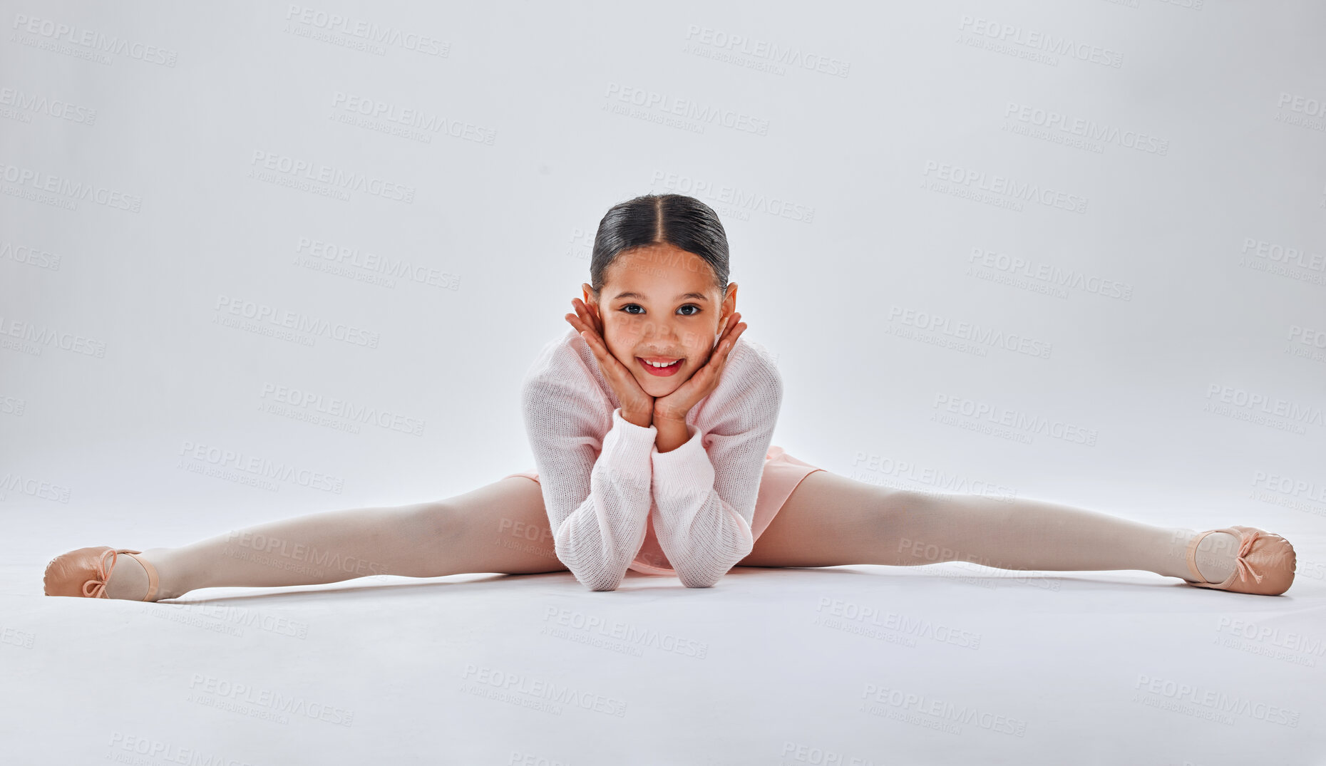 Buy stock photo Ballet, dancer and young girl doing the split, smile in portrait with fitness, dancing and sport isolated on white studio background. Ballerina, training and dance in studio, athlete and stretching