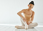 Woman, ballet shoes and tie ribbons for performance, dancer and prepare in dance studio. Female person, ballerina and ready for practice, competition and recital, artist and art academy or school