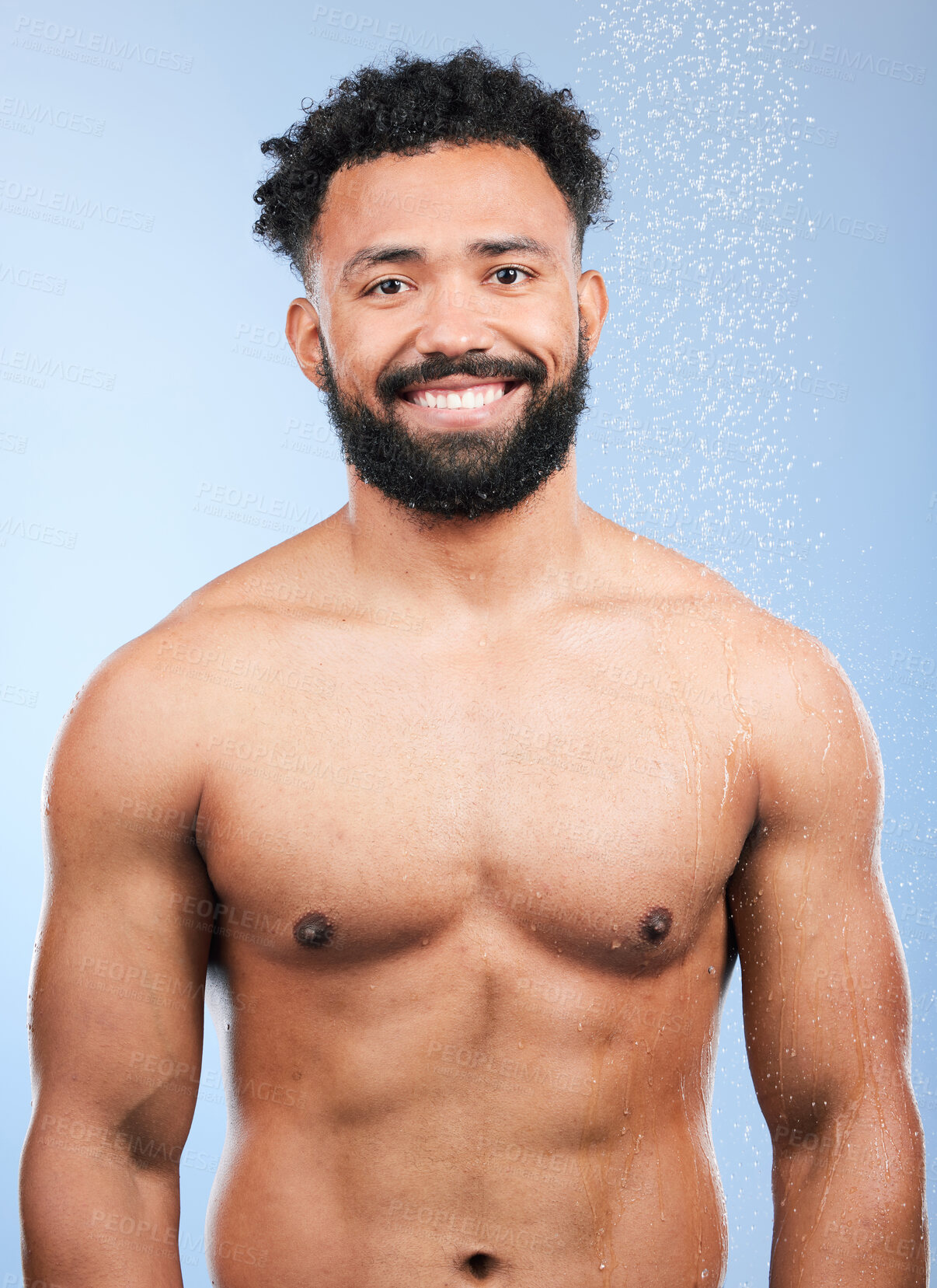 Buy stock photo Shower, cleaning and man with portrait and smile from water, skincare and morning routine. Bathroom, cosmetics and male model in a studio with blue background and dermatology for wellness and wash