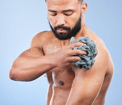 Buy stock photo Shower, washing and man with sponge in studio for cleaning, hygiene and skincare on blue background. Dermatology, bathroom and person with soap, drops and cosmetics for wellness, health or self care