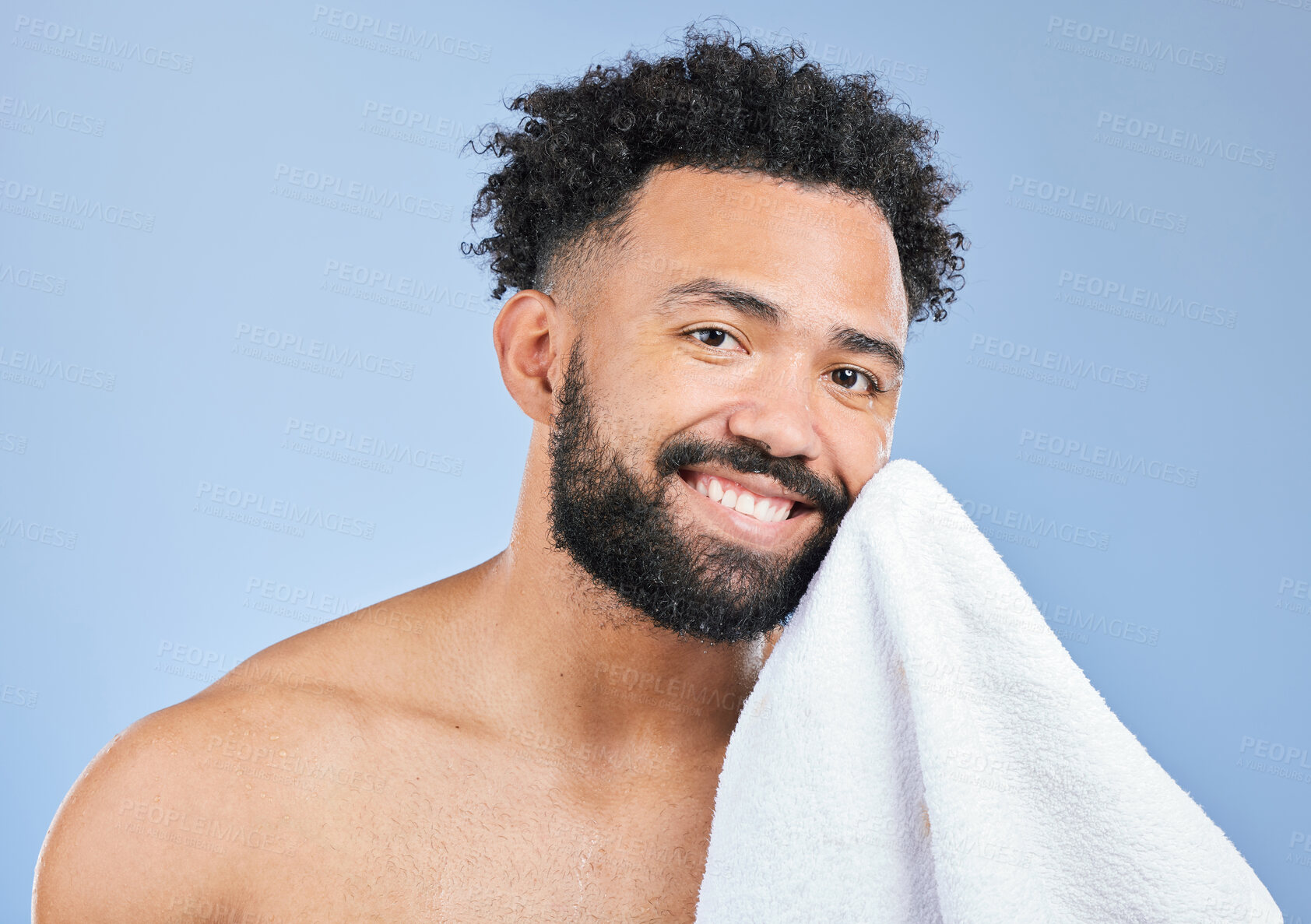 Buy stock photo Shower towel, portrait smile and man with morning routine, facial cleaning or studio self care, wash and grooming. Bathroom, spa salon and model skin hygiene, wellness and dry face on blue background