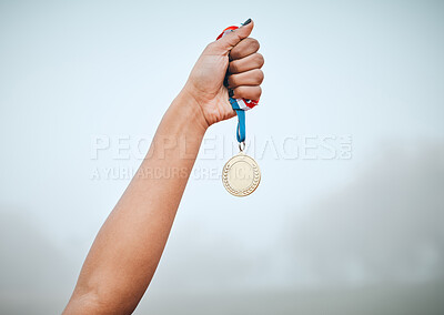 Buy stock photo Fitness, hand and the medal of a winner with a person outdoor on a foggy or misty morning for sports. Exercise, award and success with an athlete holding gold in celebration of a race victory
